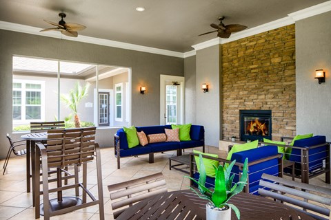 a living room with a fireplace and a table with chairs